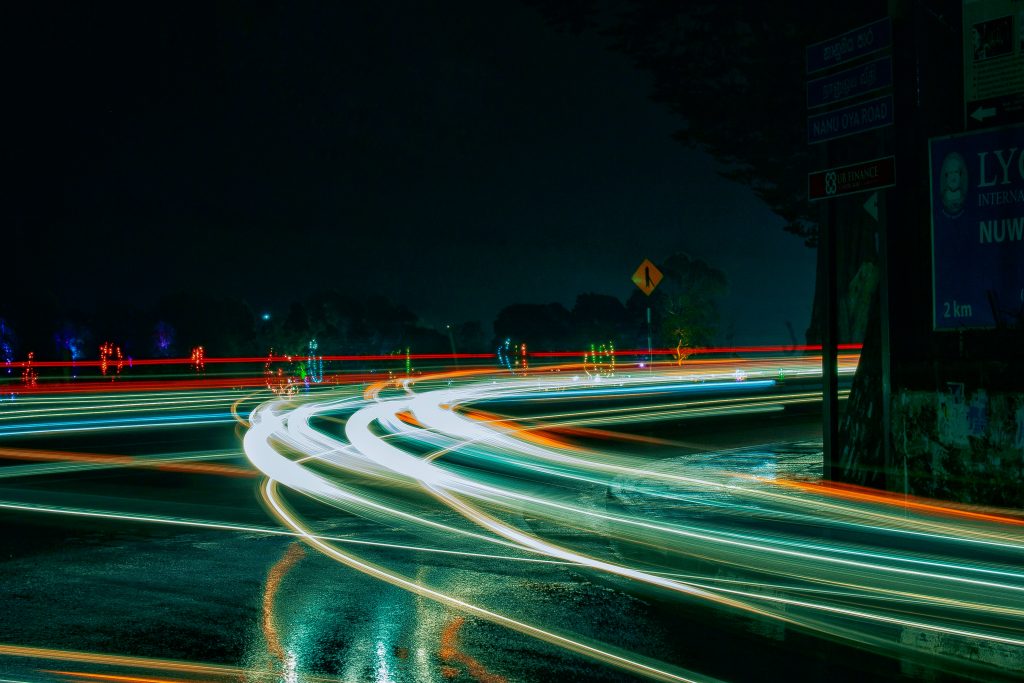 Image of a time-lapsed highway showing lights that indicate the passage of cars.