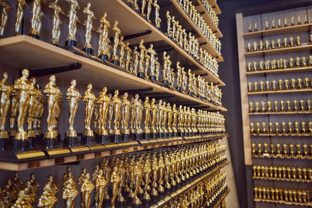 Image of many shelves full of golden Oscar trophies