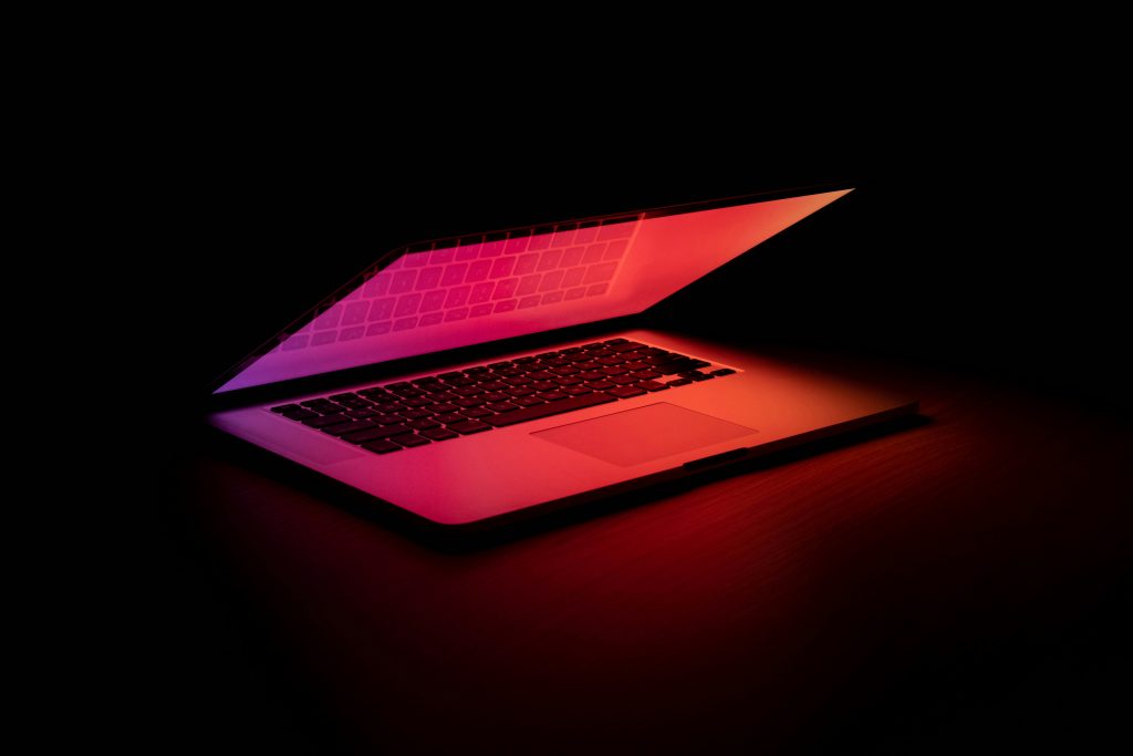 Image showing half-open laptop, glowing ominously red.